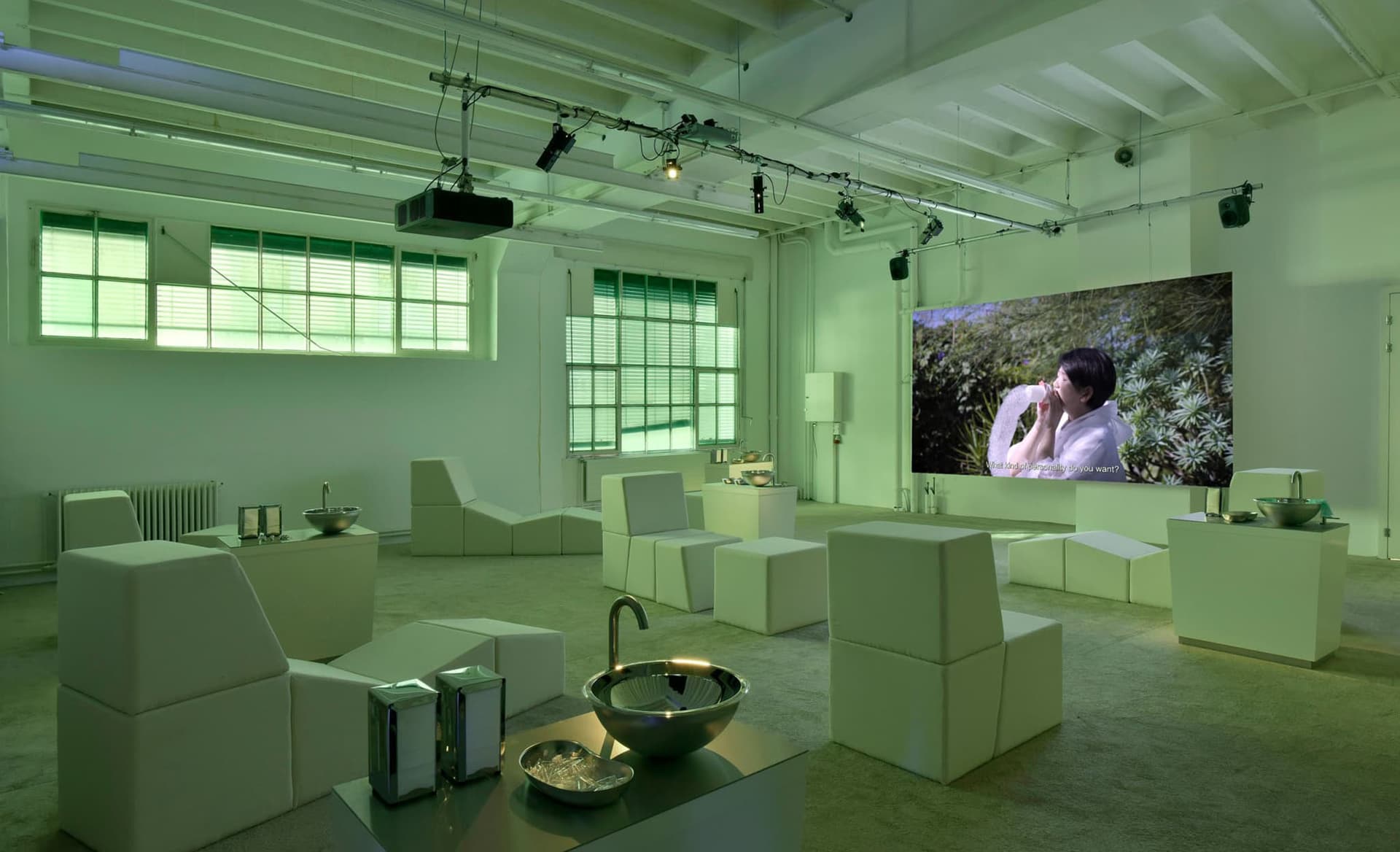 Lauren Lee McCarthy, Saliva Retreat, 2024. A group of participants were invited to a 'Saliva Retreat' performance where they sought out a partner for saliva swapping and were guided through the negotiation of terms and process of exchange. Exhibition view of the Biennale de l’Image en Mouvement 2024, A Cosmic Movie Camera, at Centre d’Art Contemporain Genève curated by Nora N. Khan and Andrea Bellini, scenography conceived by FormaFantasma. Courtesy: Mathilda Olmi © Centre d’Art contemporain Genève.